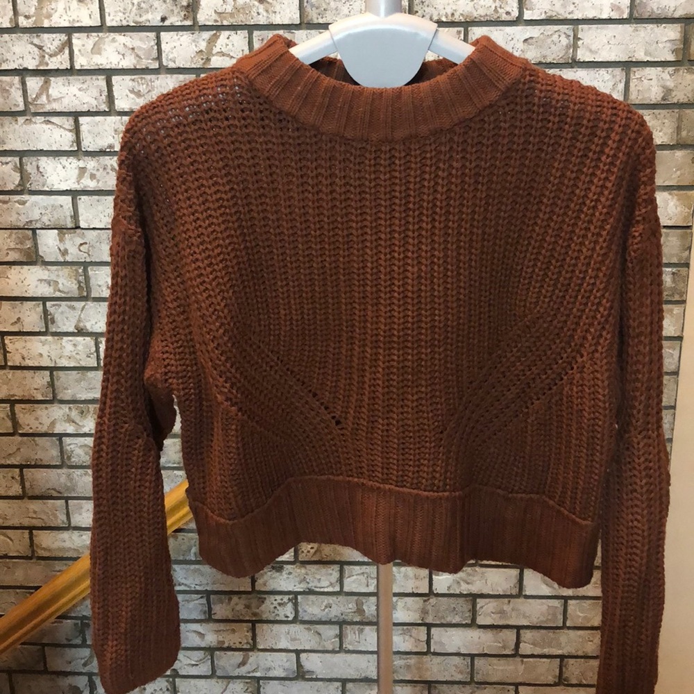 Cropped cable-knit sweater.